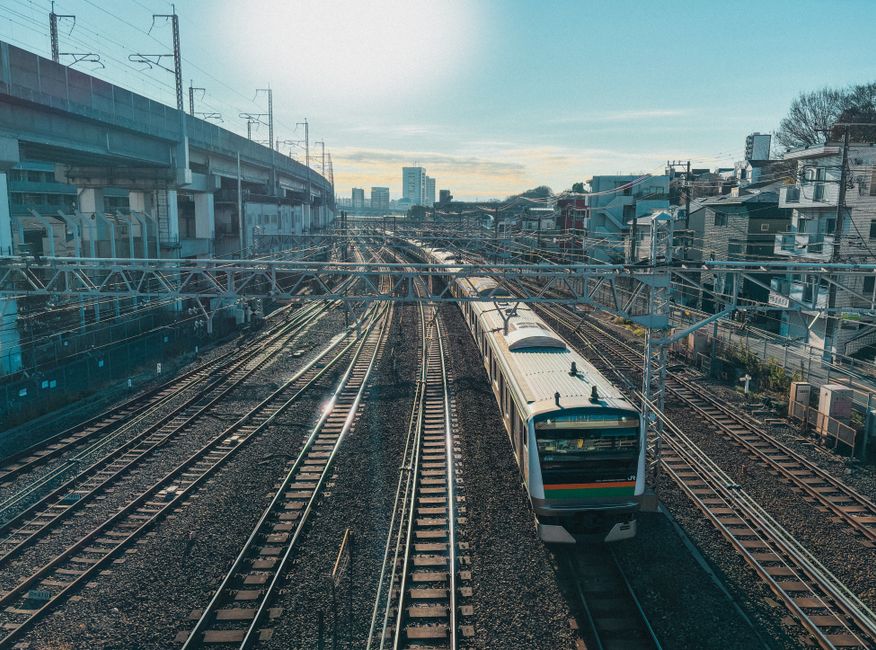 Captivating aerial view of train tracks with a train in Tokyo's Kita Ward, capturing urban life.