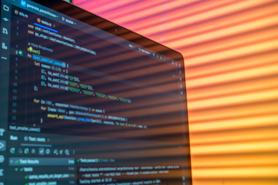 Close-up of computer code on a screen illuminated by warm lighting patterns, creating an artistic tech vibe.